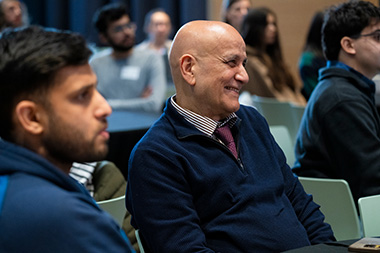 Two audience members at the Young Alumni Impact Award Ceremony.
